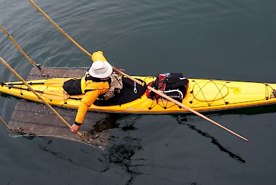 Kayakers departing from the MV Uchuck III where there are no docks are lowered overboard on a cargo raft. From there they simply paddle off on their adventure.